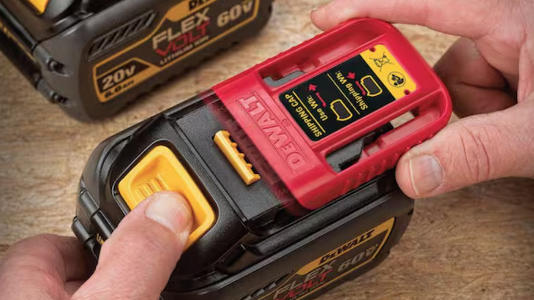 Close-up of a high-capacity DeWalt Flexvolt battery being inserted into a cordless tool.