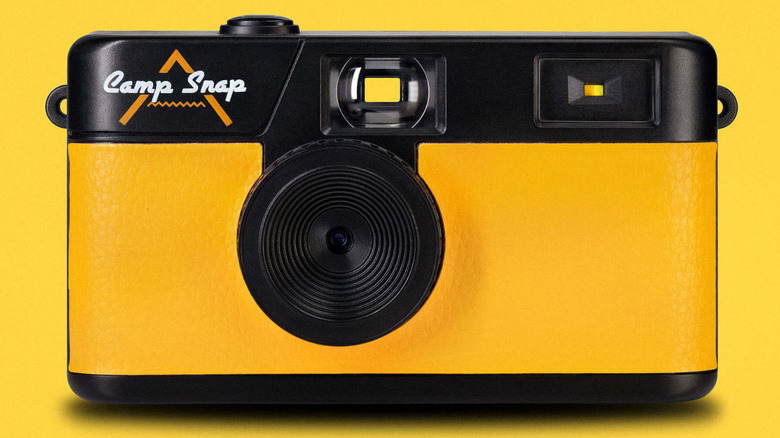 The yellow Camp Snap camera shown against a matching yellow background, highlighting its lack of a digital screen.