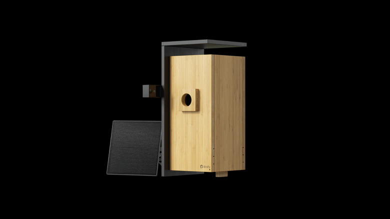 A Birdfy Nest Duo smart birdhouse made of wooden bamboo with a black background highlighting its design.
