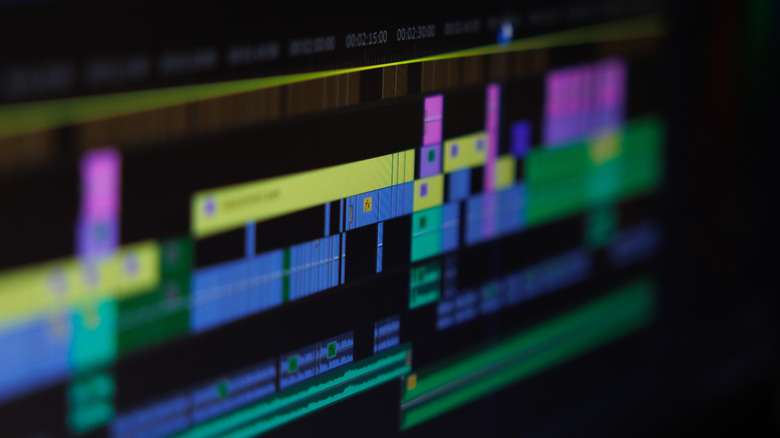 A computer screen displaying a complex video editing timeline with multiple layers and color-coded clips.