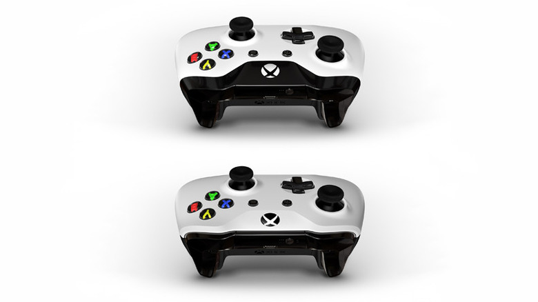 Side-by-side comparison of an older Xbox One controller and a newer Bluetooth-enabled model showing the plastic faceplate differences.