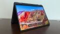 A Dell 2-in-1 laptop standing in tent mode on a desk.