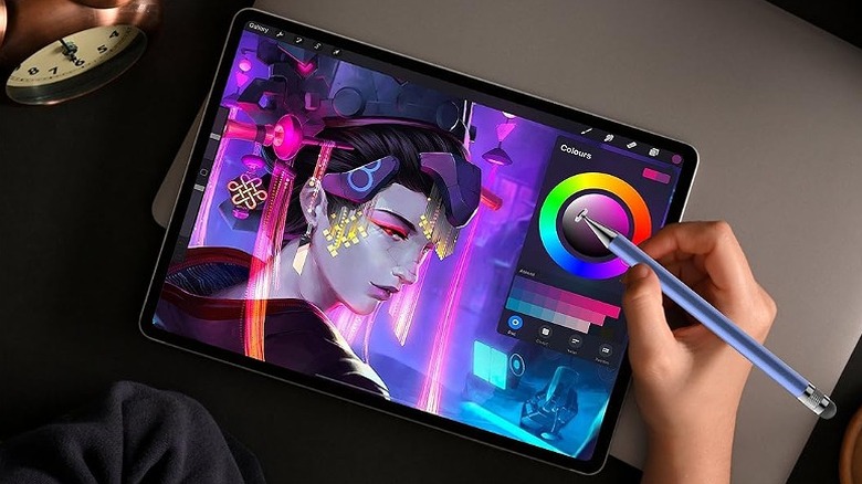 An artist using a stylus for detailed graphics editing and retouching on a digital screen.