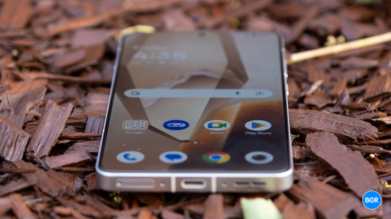 The front display of the OnePlus 13R powered on, showing the vibrant home screen.