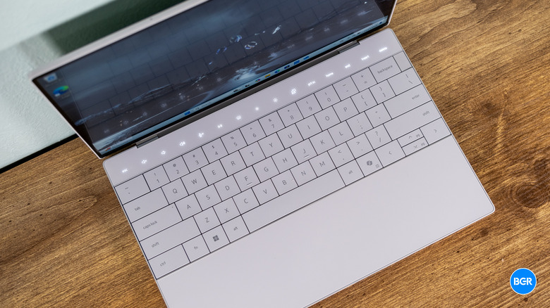Top-down view of the Dell XPS 13 9350 zero-lattice keyboard and the seamless glass haptic touchpad.