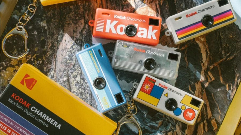 Several retro-styled Kodak cameras laid out together on a table.