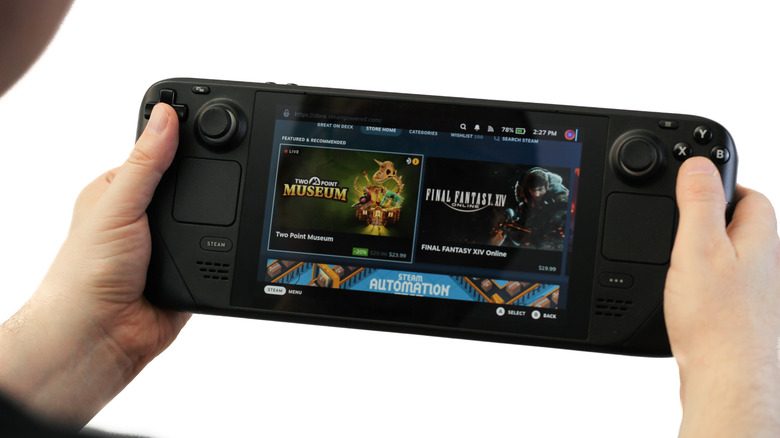 A person holding a Steam Deck with the Steam store visible on the screen.