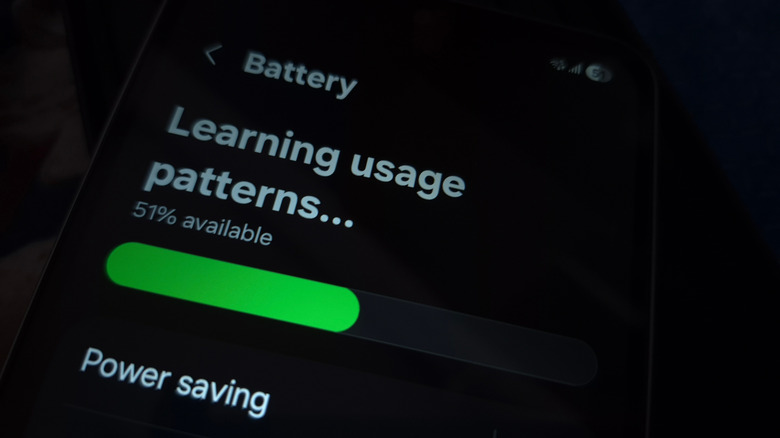 A conceptual view of a smartphone screen showing icons representing app usage learning and battery analysis.