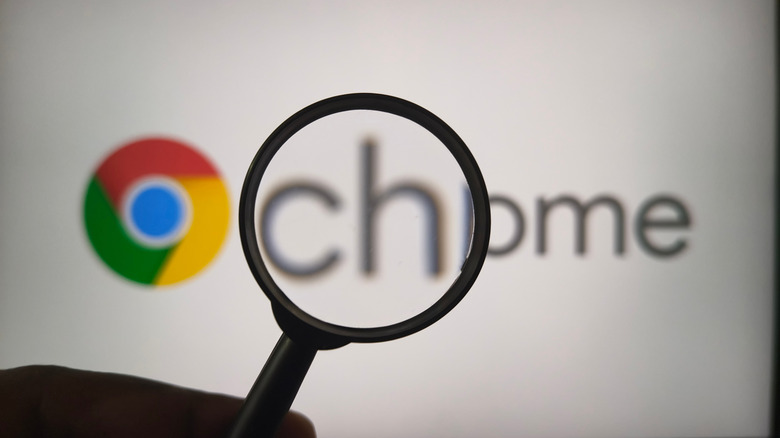 A magnifying glass positioned over the Google Chrome browser logo.