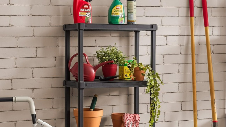 Black storage rack holding various organized household and gardening items.