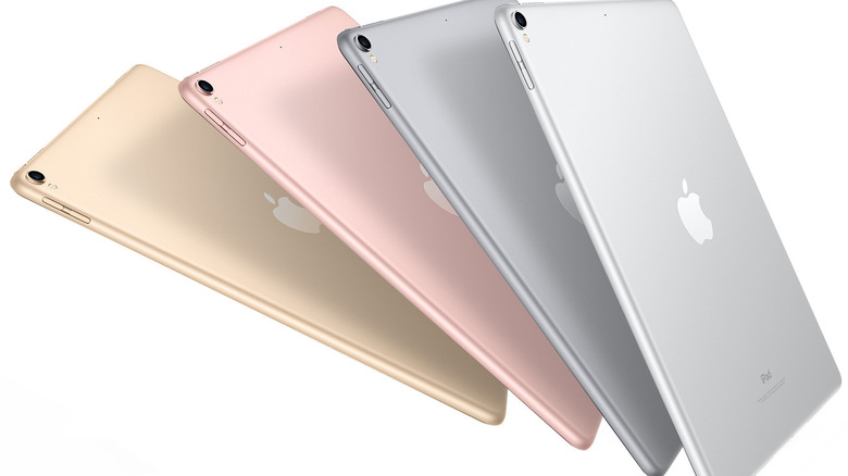 A row of various iPad models in different colors like silver, gold, and space gray.