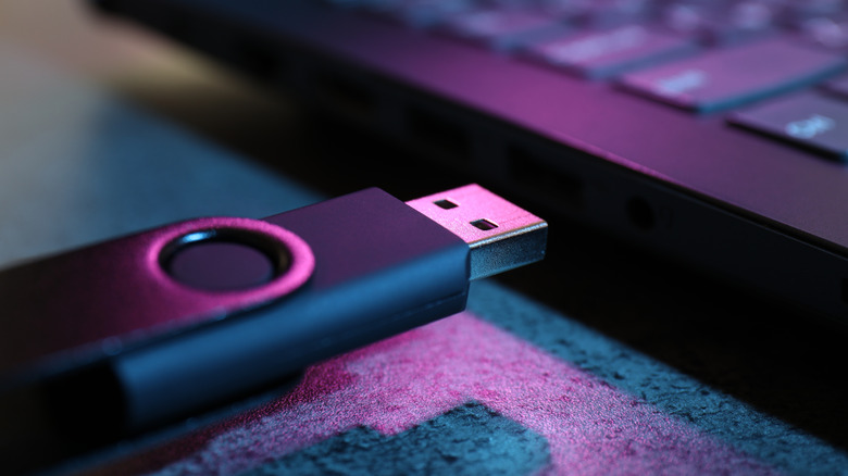 Close-up of a USB drive connection, highlighting the physical link required for lossless audio playback.