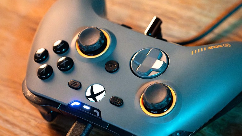 A Scuf Valor Pro controller resting on a table while connected to a USB-C cable.