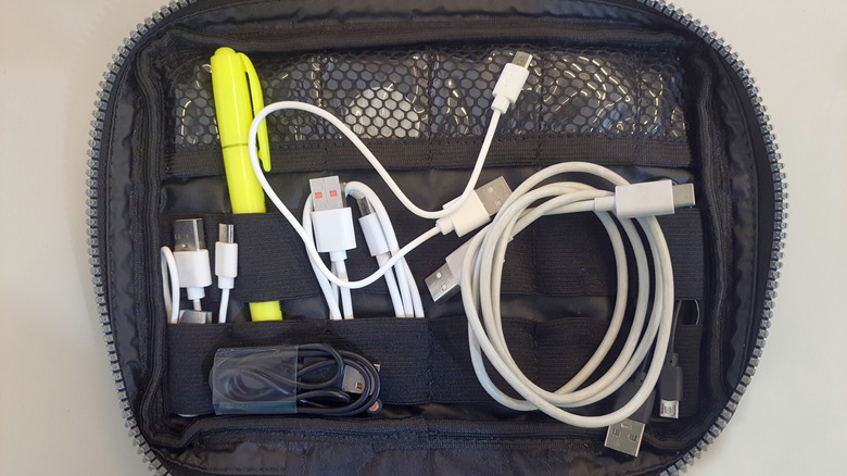 A dedicated tech travel bag organized with various USB cables and accessories.
