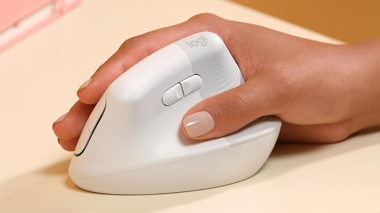 Close-up of a hand using a Logitech Lift vertical ergonomic mouse to demonstrate proper wrist alignment.