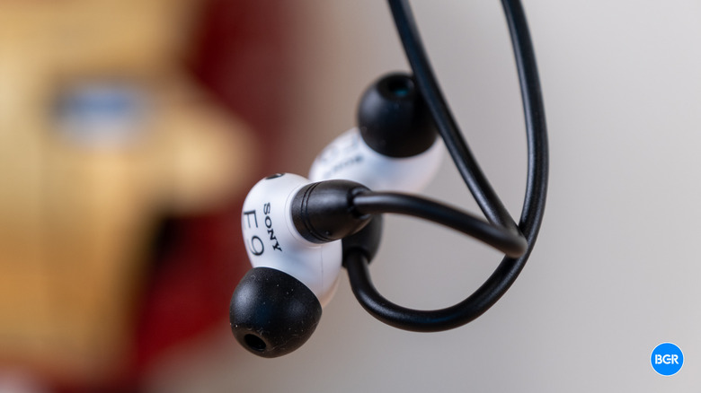 Sony Inzone E9 earbuds suspended in the air to demonstrate their lightweight design.