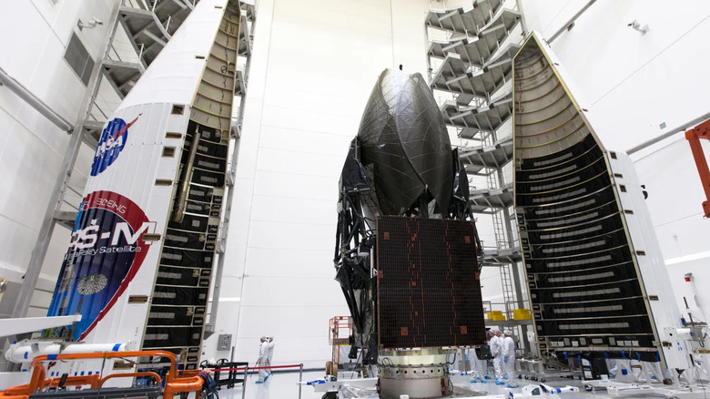 The TDRS-13 satellite being carefully packed into a shipping container for transport to the launch site.