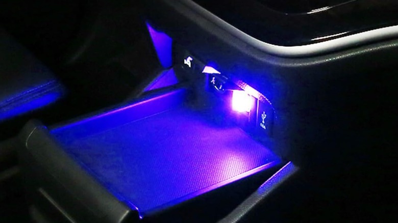 A blue Augeny USB LED interior lamp plugged into a vehicle port, casting a vibrant glow across the cabin.