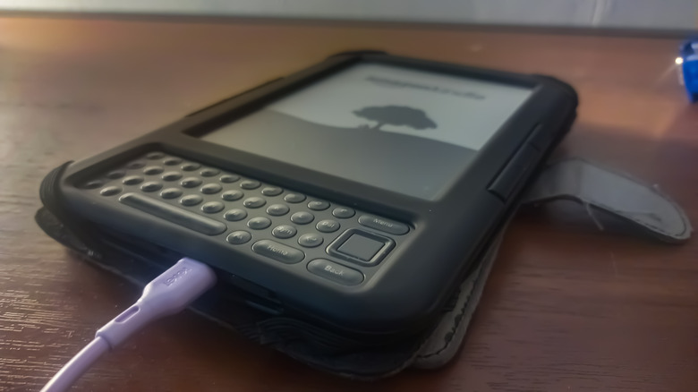 Top-down view of an older model Kindle with a physical QWERTY keyboard.