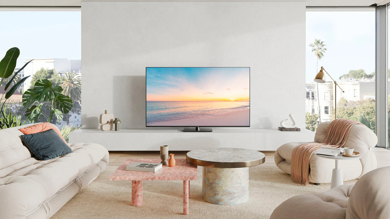A Panasonic Z85A sitting on a wooden TV stand in a cozy living room.