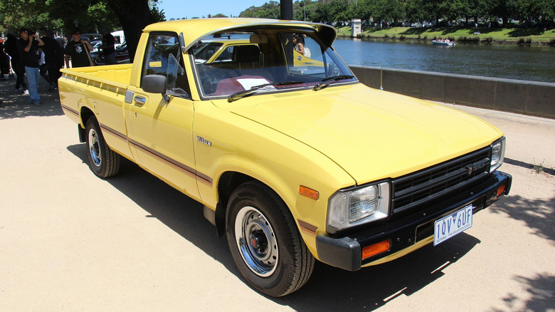 A clean, stock 1982 Toyota Hilux pickup truck in a metallic finish