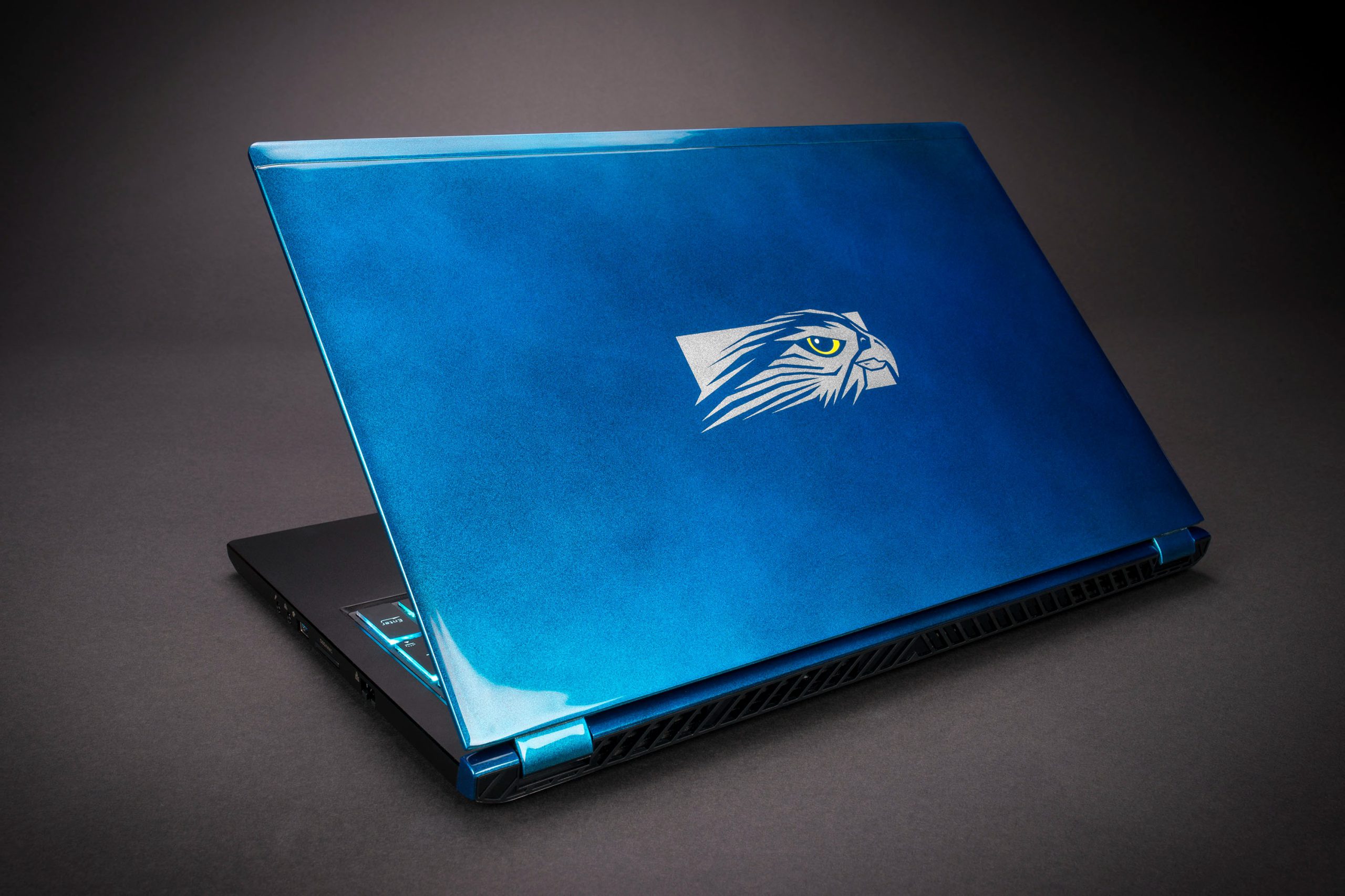 Close-up of a premium gaming laptop's rear exhaust vents and heat sink assembly.