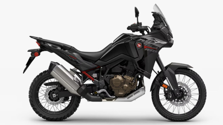 A Honda Africa Twin adventure motorcycle with its digital instrument cluster visible.