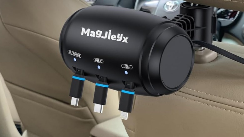 A Magjieyx Retractable Car Station Box mounted on the back of a front seat headrest for passenger use.
