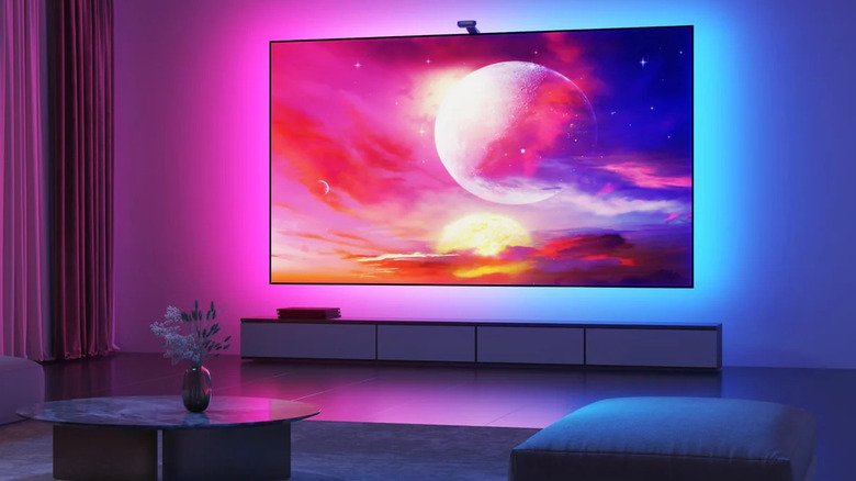 A modern living room setup featuring a TV with the Govee Envisual T2 backlighting system active.