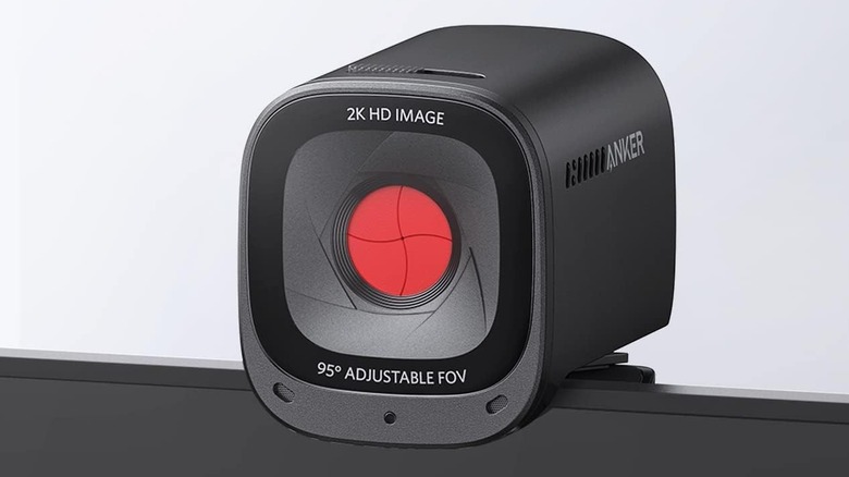 An Anker PowerConf 2K webcam with a physical privacy shutter mounted on top of a screen.
