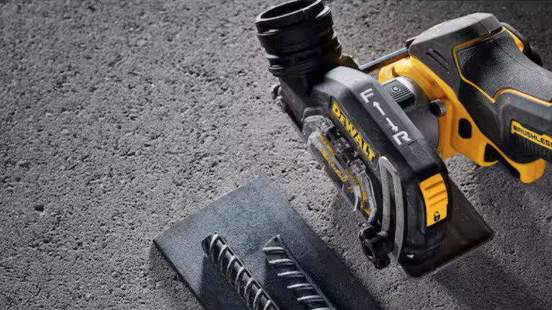 A DeWalt cordless cutoff tool in use with sparks flying during a metalworking task.