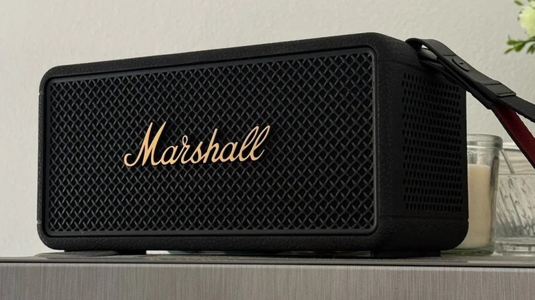 A Marshall Middleton 2 Bluetooth speaker placed on a wooden desk surface.