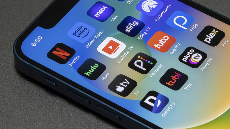 Close-up of various streaming app icons on an iPhone home screen.