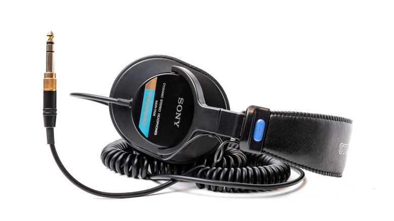 Professional Sony MDR-7506 wired headphones featuring the classic blue sticker and coiled cable.