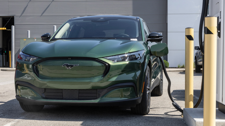 A Ford Mustang Mach-E charging at a station, showcasing its high-tech design.