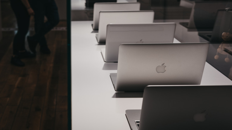 A lineup of different MacBook models displayed on a desk showing various form factors.