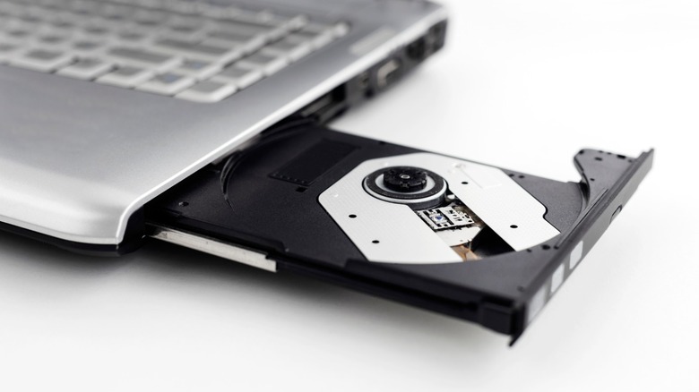 A laptop with its internal DVD drive tray ejected.