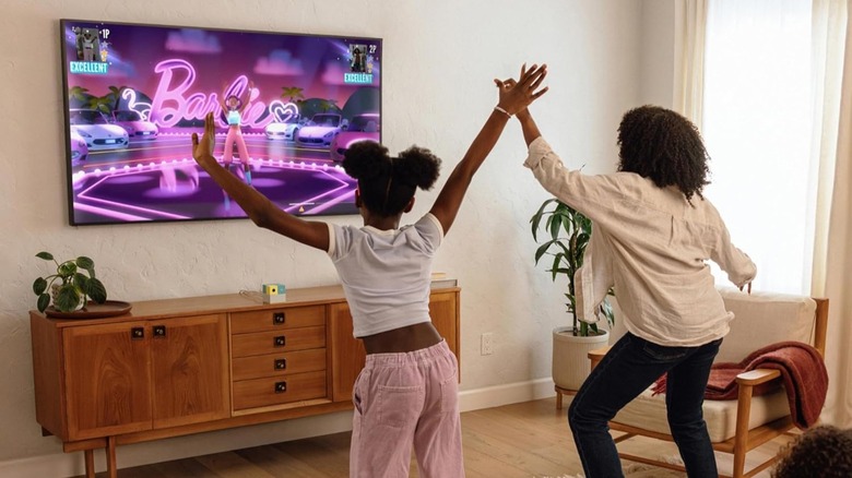 A family of four engaging in active motion-tracked gameplay using the Nex Playground console in their living room.