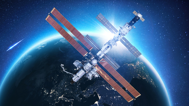 The International Space Station captured against the dark background of space and the curve of Earth.
