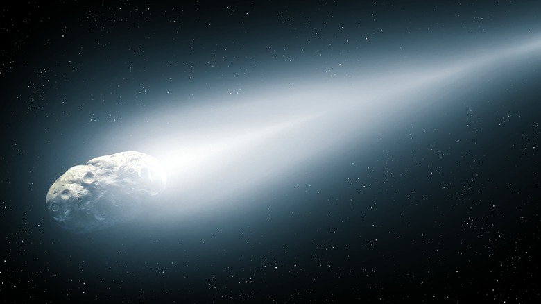 An illustration of a comet featuring a bright white nucleus and a long, sweeping blue and white tail.