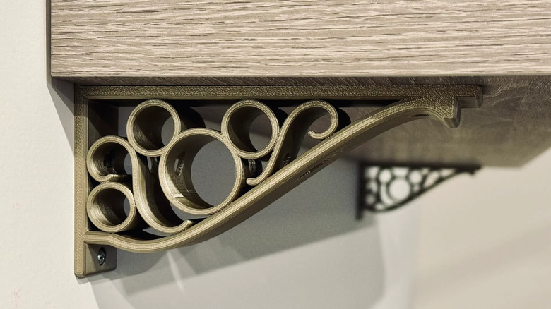 A sturdy 3D printed shelf bracket mounted to a wall and supporting a wooden shelf.