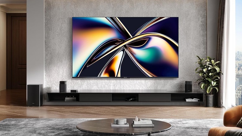 A Hisense 75-inch ULED TV mounted on a modern living room wall displaying a bright cinematic landscape.