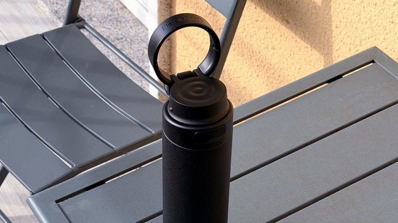 The HidrateSpark Pro 2 being carried by its integrated handle.