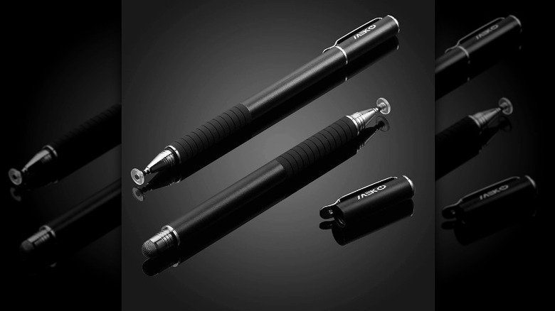 Two minimalist black stylus pens positioned on a dark, reflective background.