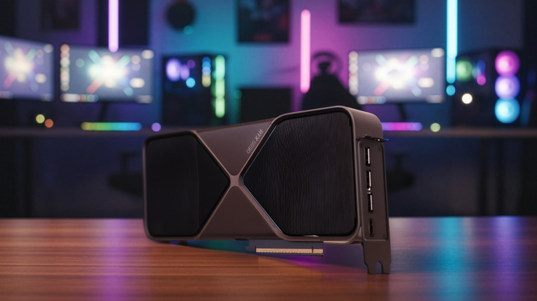An RTX 5090 graphics card resting on a desk with vibrant, colorful backlighting.