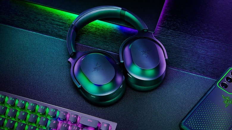 A Razer Barracuda Pro Wireless Gaming Headset resting on a gaming desk.