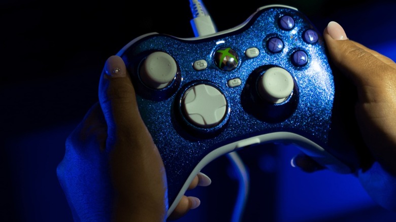 A handheld shot of a blue Hyperkin Xenon controller showcasing its retro design.