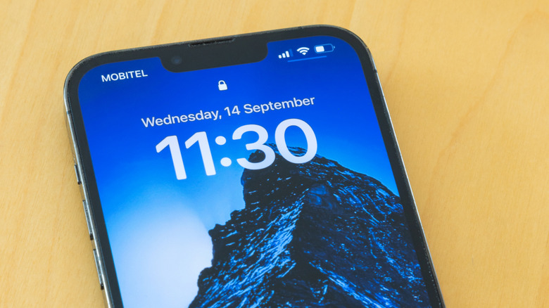 Close-up shot of an iPhone with a reduced notch highlighting the clarity of the OLED panel.