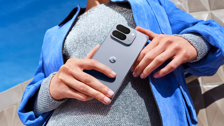 A side view of a person holding a Google Pixel 10 Pro Fold in its unfolded tablet state.