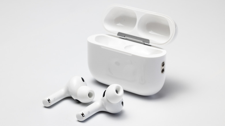Close-up of AirPods Pro earbuds and their charging case.
